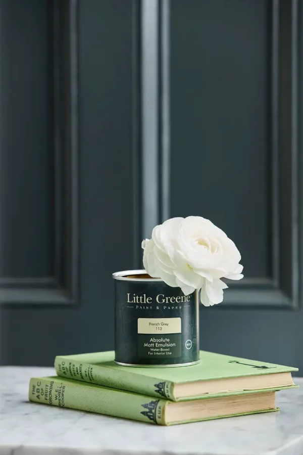 tin on books with rose